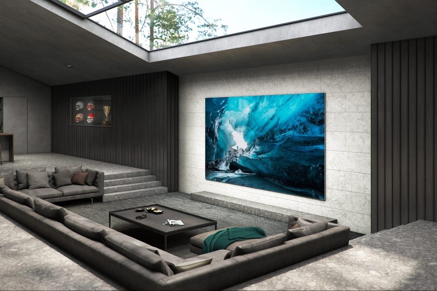 Interior of a luxury home theater with a skylight, lounge seating, and an ultra-bright micro-LED display. 